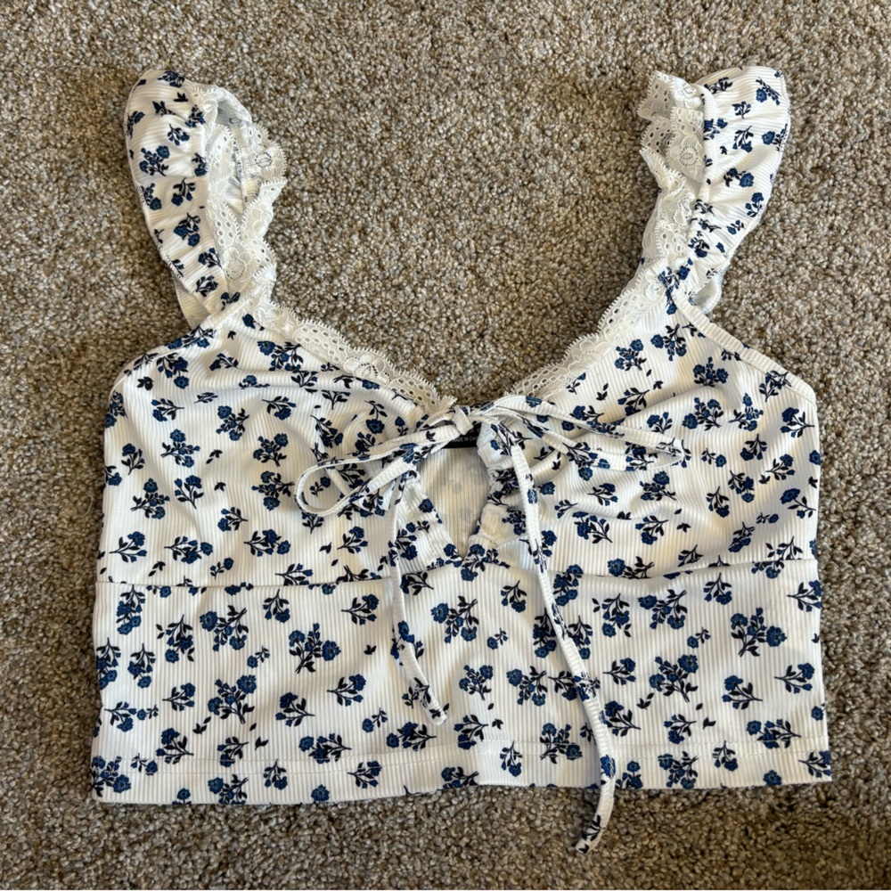 Crop floral tank with ruffle trim, lace detail and front tie